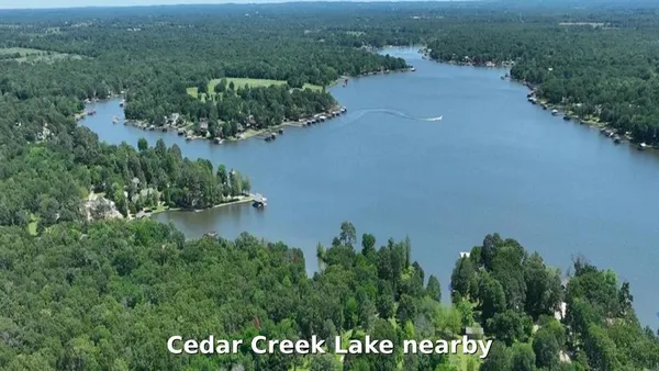 an aerial view of a houses with a yard