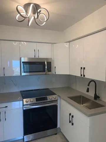 a kitchen with a stove and a sink