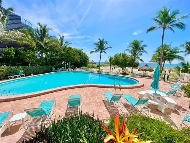 a view of a swimming pool with a chair and tables