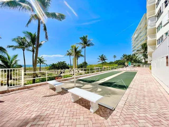 a view of a swimming pool with a table and chairs