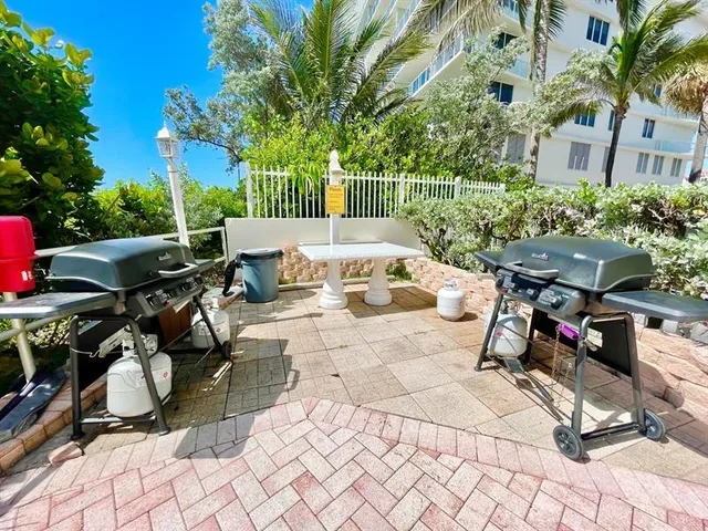 a view of a backyard with sitting area and furniture