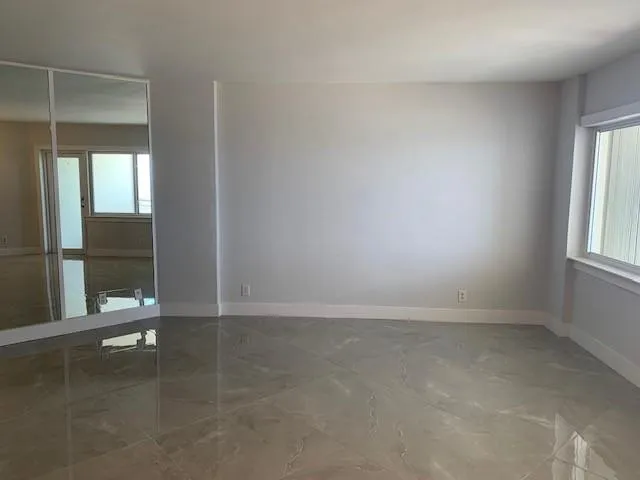 an empty room with windows and entrance