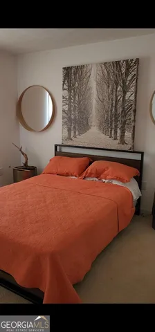 a bed sitting in a bedroom next to a window