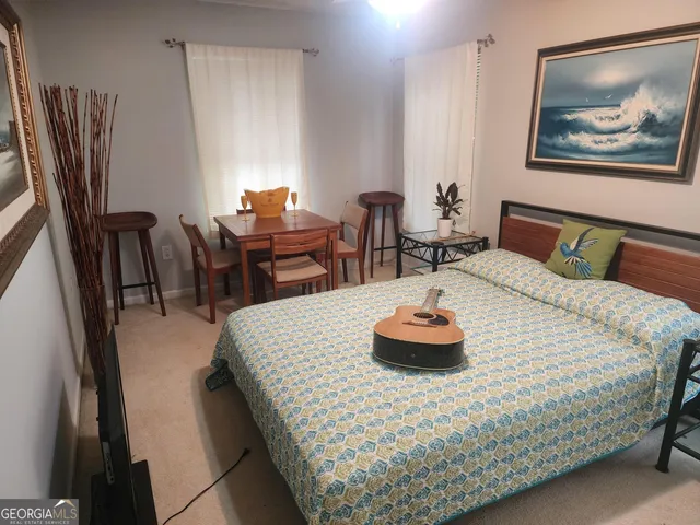 a bedroom with furniture and a large window