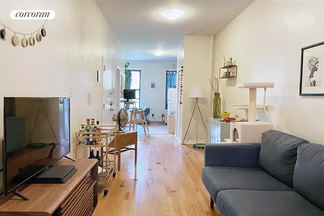a living room with couches and a flat screen tv
