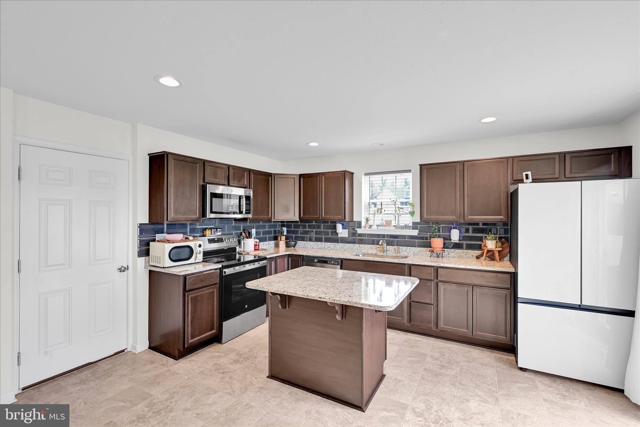 2625 Village Road Dover, PA 17315 - Photo 6 of 15 a kitchen with stainless steel appliances granite countertop a refrigerator a sink a stove and a refrigerator