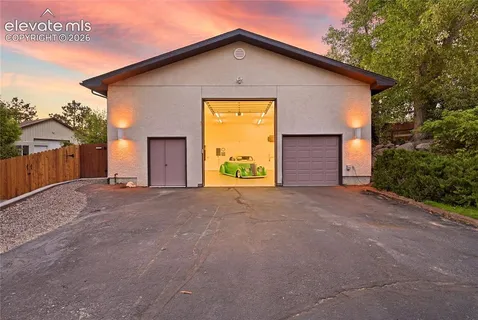 a view of a house with a backyard and garage