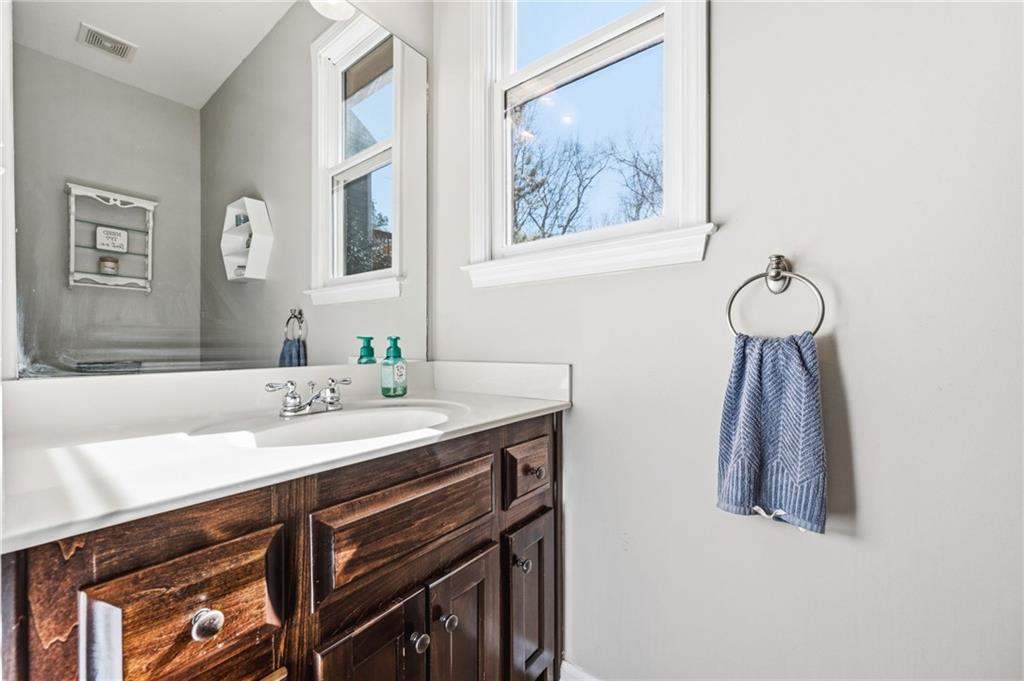 313 Spring Hill Drive Canton, GA 30115 - Photo 17 of 35 a bathroom with a sink and a mirror