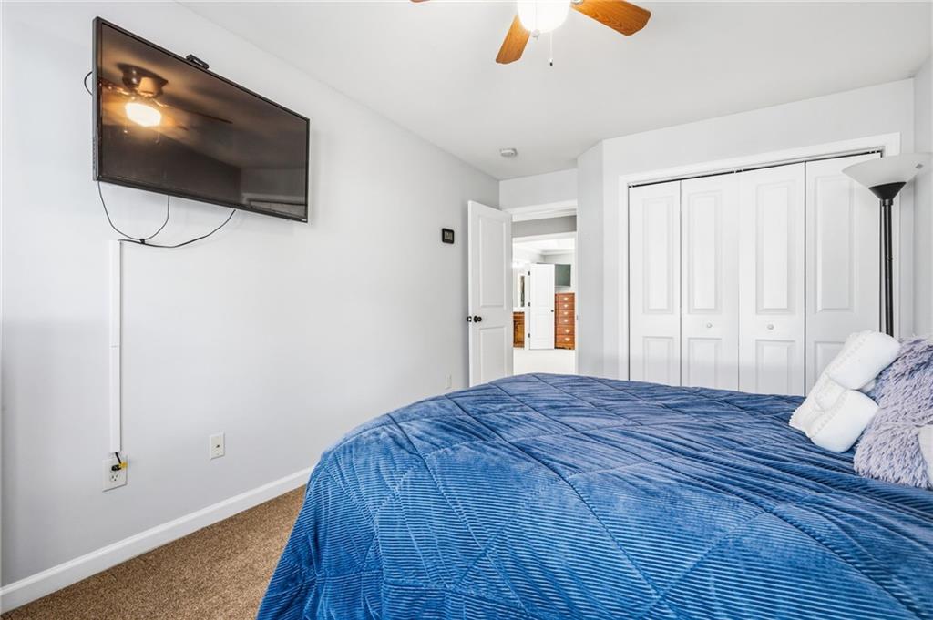 313 Spring Hill Drive Canton, GA 30115 - Photo 27 of 35 a bedroom with a bed and flat screen tv
