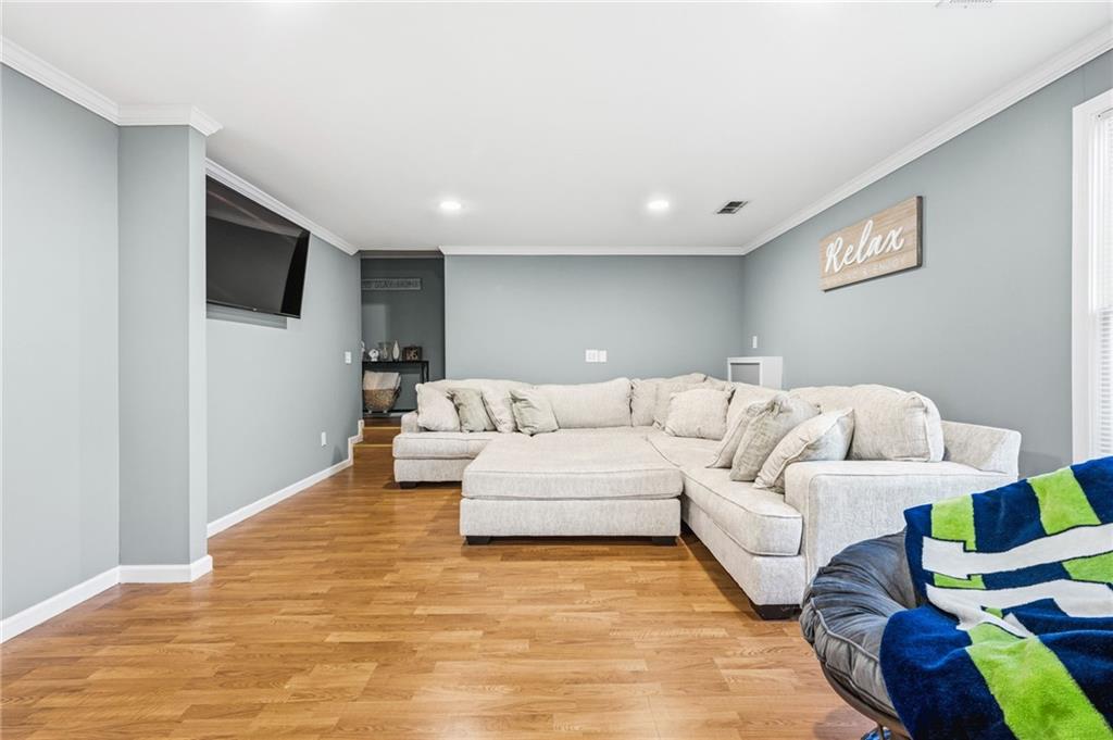 313 Spring Hill Drive Canton, GA 30115 - Photo 29 of 35 a living room with furniture and a flat screen tv