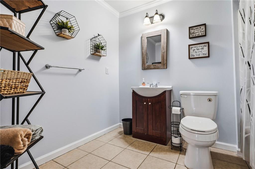 313 Spring Hill Drive Canton, GA 30115 - Photo 33 of 35 a bathroom with a toilet a sink and mirror