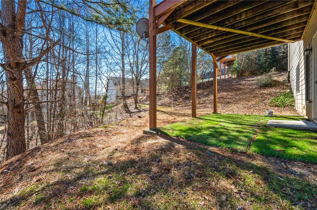 313 Spring Hill Drive Canton, GA 30115 - Photo 34 of 35 a view of small yard in front of a house with a large tree