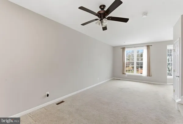 a work room with furniture and large window