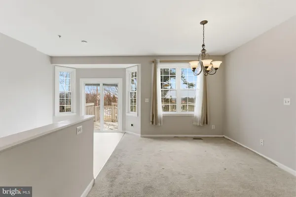 a kitchen with a refrigerator a stove a dining table and chairs