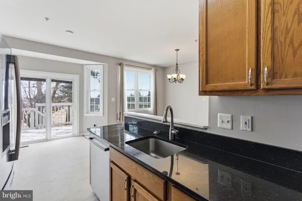 a view of a patio with couches table and chairs and potted plants