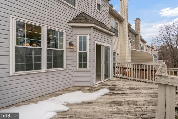 a balcony with wooden floor and fence