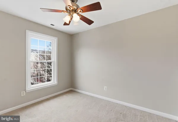 a bedroom with a large bed and a large window