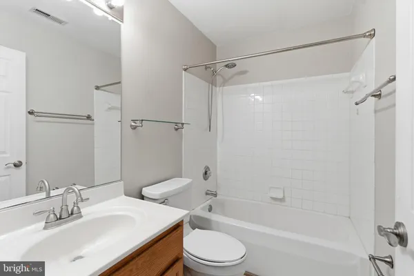 a bedroom with a bed couch and window