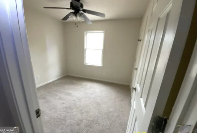 a view of an empty room and a window