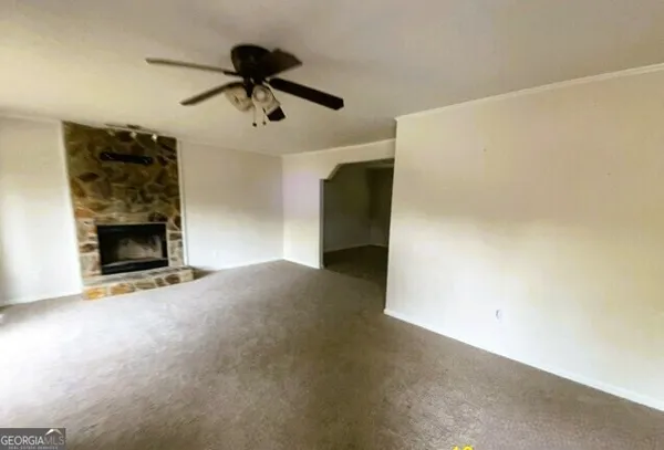 a view of empty room with a fireplace