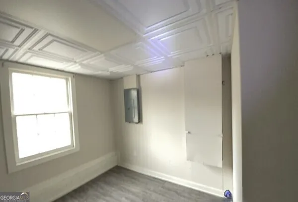 a bathroom with a window and a glass door