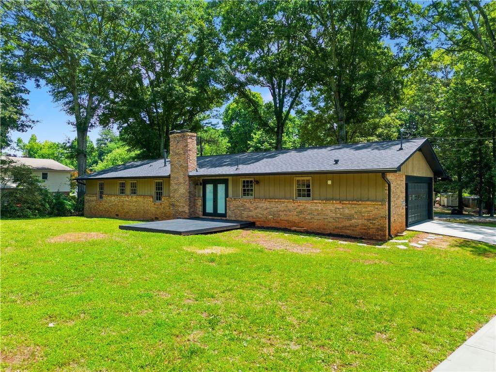 125 Childers Road Canton, GA 30115 - Photo 1 of 48 a front view of a house with yard and green space