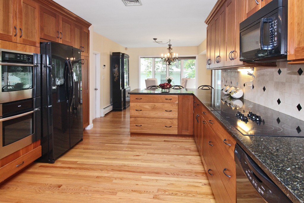 83 Spring Valley Road Belmont, MA 02478 - Photo 11 of 30 a kitchen with stainless steel appliances granite countertop a stove a sink and a refrigerator