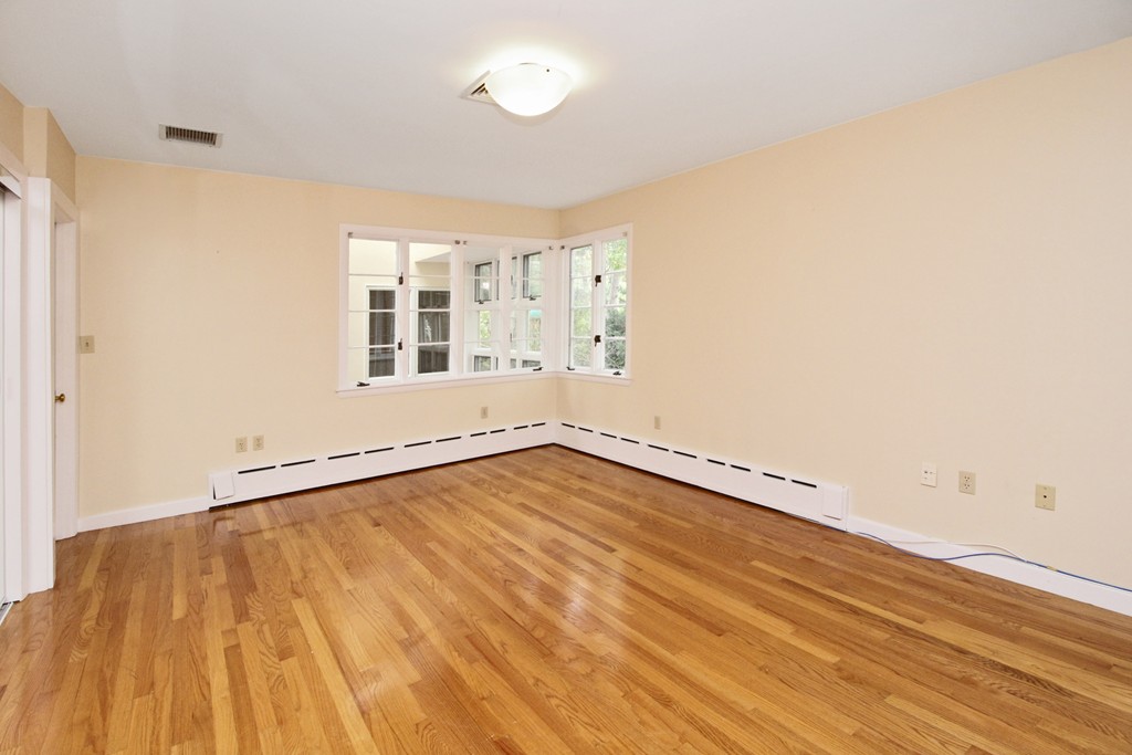 83 Spring Valley Road Belmont, MA 02478 - Photo 17 of 30 an empty room with wooden floor and windows