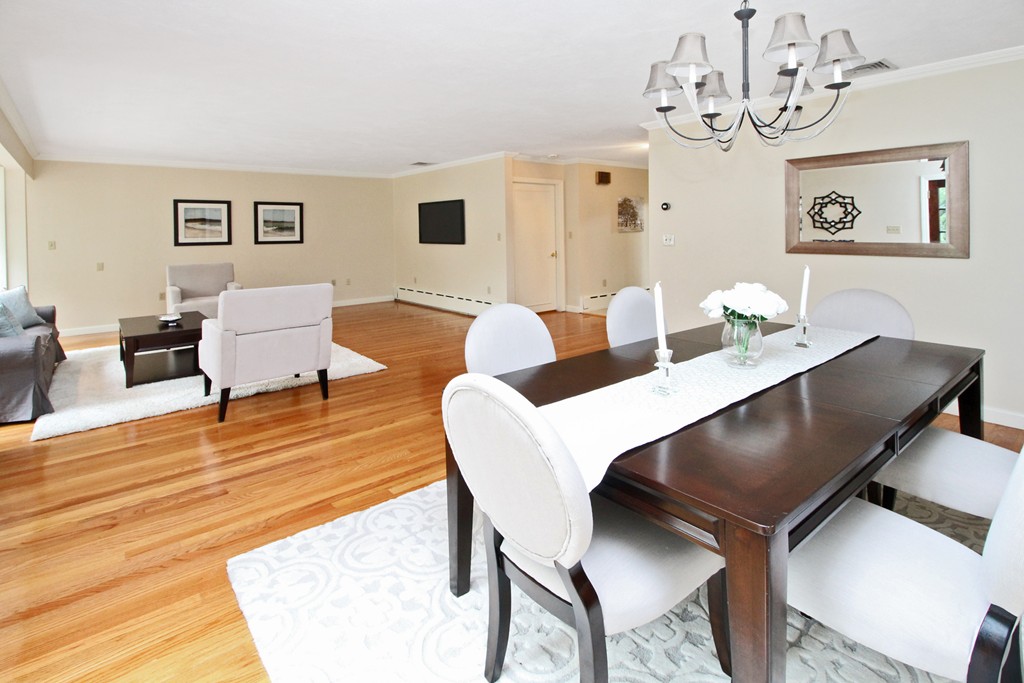 83 Spring Valley Road Belmont, MA 02478 - Photo 4 of 30 a living room with couches a dining table and chairs with wooden floor
