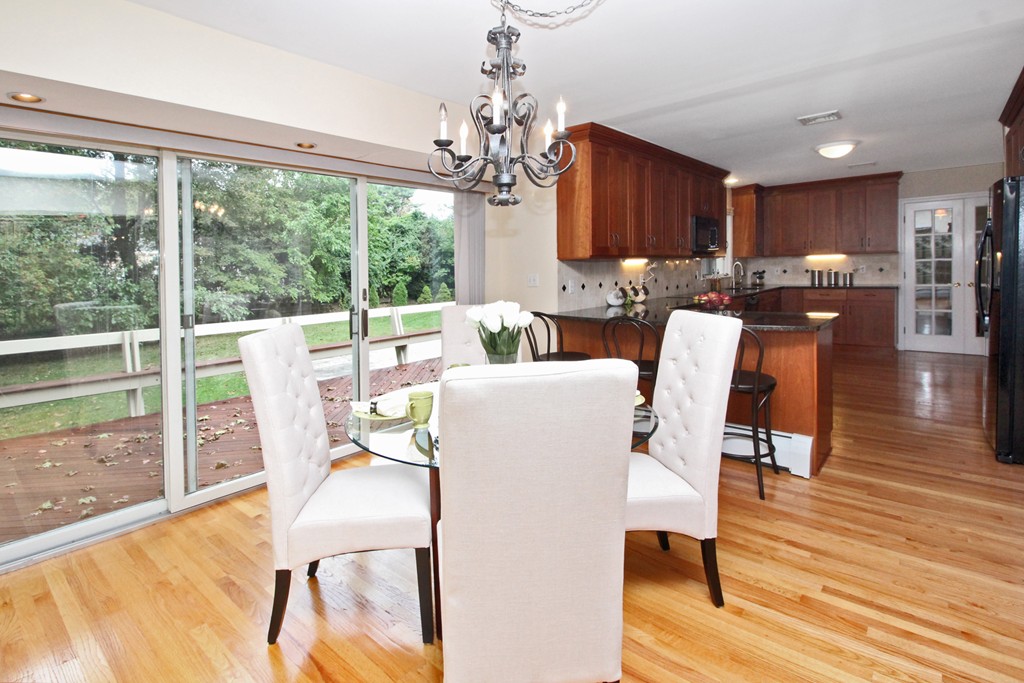 83 Spring Valley Road Belmont, MA 02478 - Photo 7 of 30 a dining room with furniture a chandelier and wooden floor