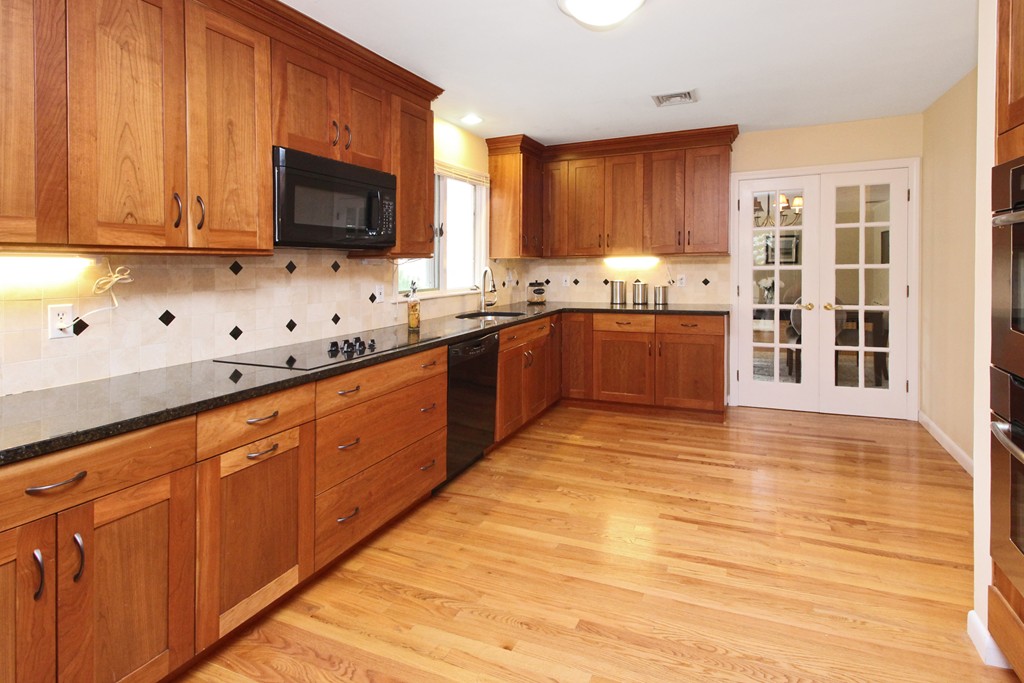 83 Spring Valley Road Belmont, MA 02478 - Photo 10 of 30 a large kitchen with stainless steel appliances granite countertop a stove a sink and a microwave