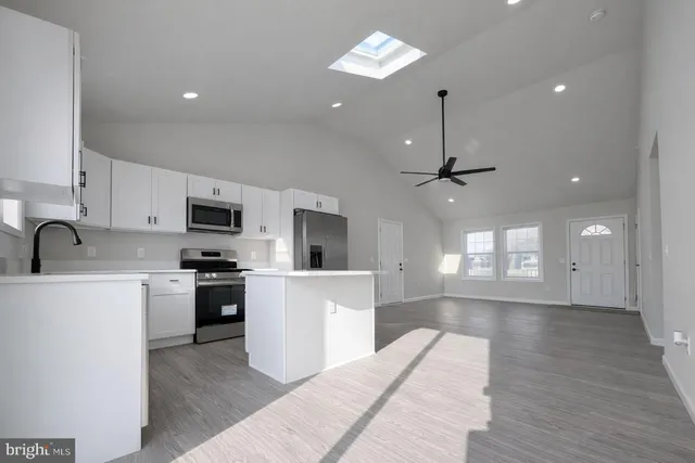 a large kitchen with stainless steel appliances kitchen island a stove a sink a center island and a refrigerator