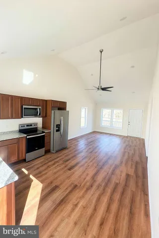 a view of kitchen with sink microwave and refrigerator