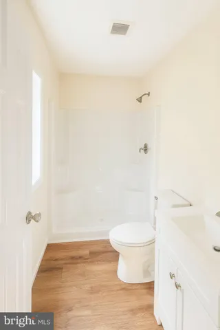 a bathroom with a toilet and a shower