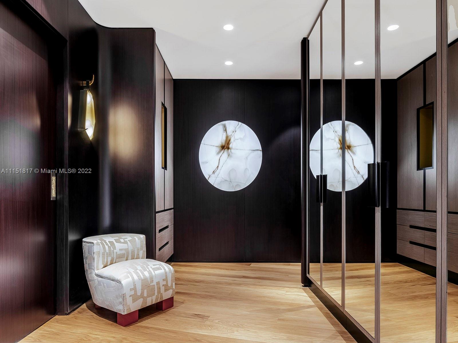 810 Lakeview Drive Miami Beach, FL 33140 - Photo 18 of 35 a living room with a furniture a mirror and a glass door