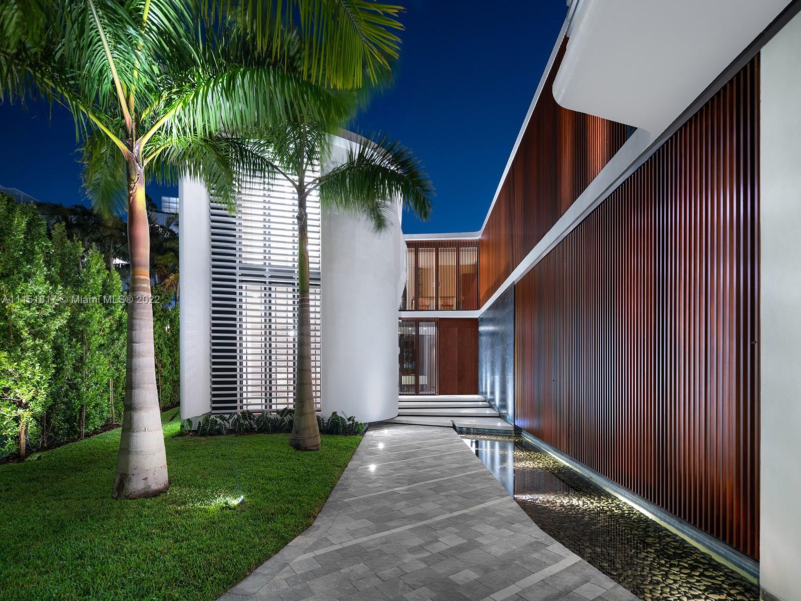 810 Lakeview Drive Miami Beach, FL 33140 - Photo 29 of 35 a house with palm tree in front of it