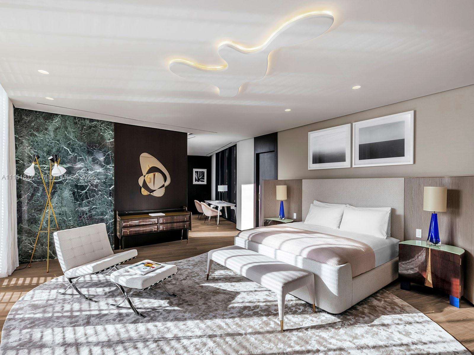 810 Lakeview Drive Miami Beach, FL 33140 - Photo 6 of 35 a spacious bedroom with a bed a mirror and lamp