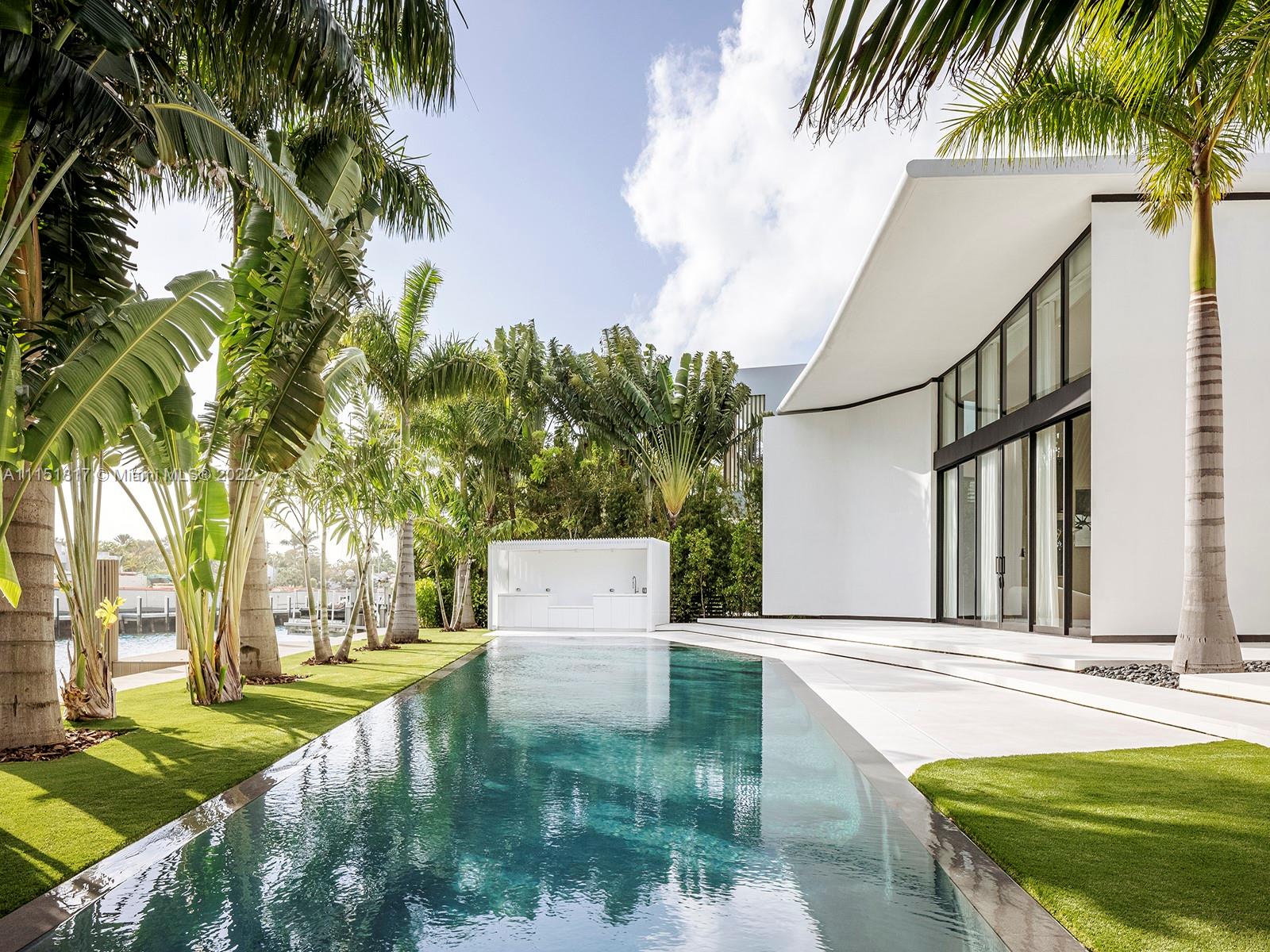 810 Lakeview Drive Miami Beach, FL 33140 - Photo 9 of 35 a view of a house with swimming pool and sitting area