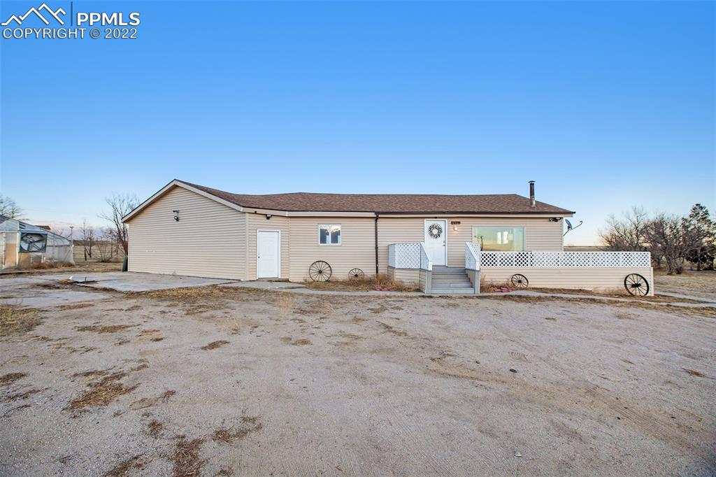 a big house with a oven and wooden fence