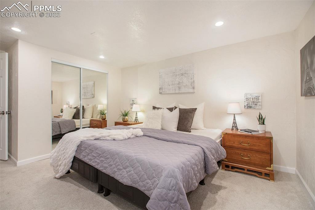 1495 North Yoder Road Yoder, CO 80864 - Photo 21 of 25 a bedroom with a bed and a lamp