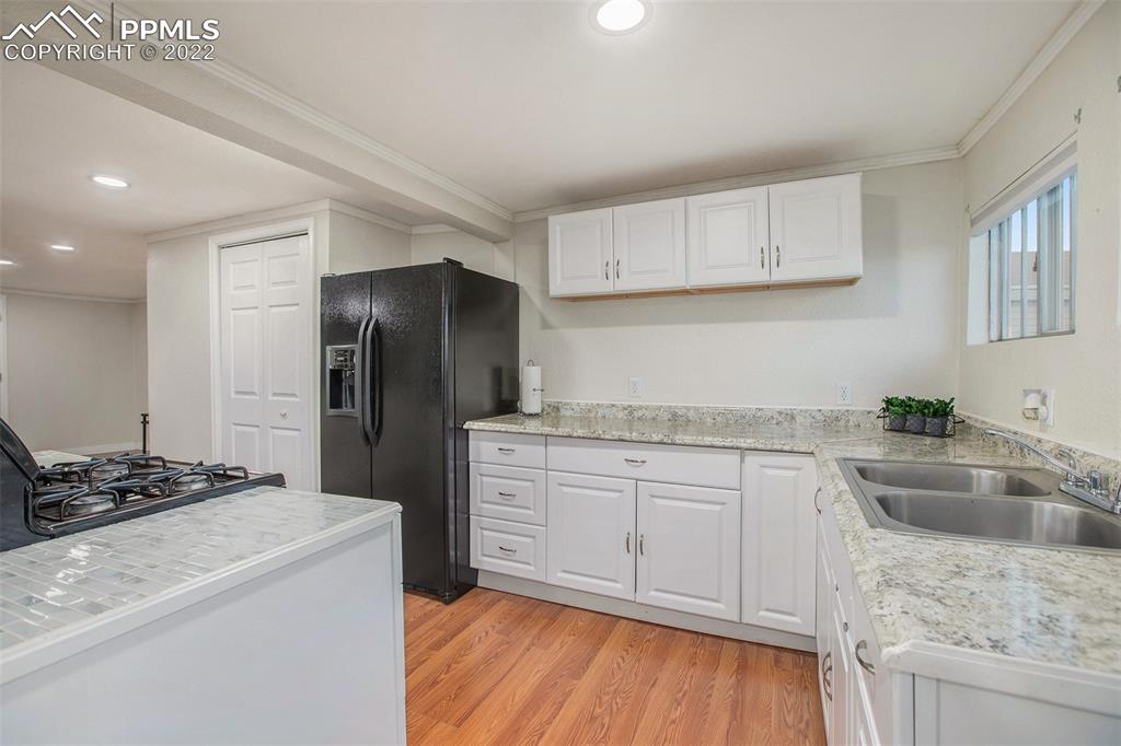 1495 North Yoder Road Yoder, CO 80864 - Photo 4 of 25 a kitchen with a sink stove and refrigerator