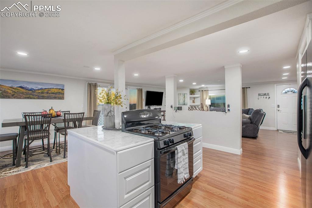 1495 North Yoder Road Yoder, CO 80864 - Photo 5 of 25 a view of a kitchen with furniture and wooden floor