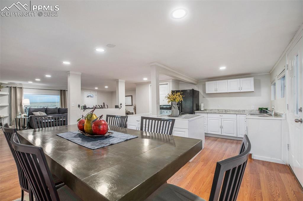 1495 North Yoder Road Yoder, CO 80864 - Photo 6 of 25 an open kitchen with dining table and chairs