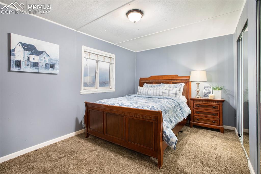 1495 North Yoder Road Yoder, CO 80864 - Photo 8 of 25 a bedroom with a bed and a window