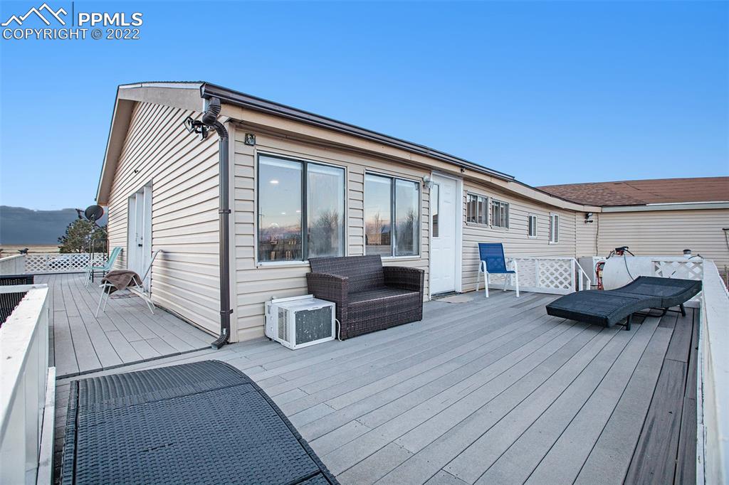 1495 North Yoder Road Yoder, CO 80864 - Photo 10 of 25 a view of a house with a barbeque and wooden stairs