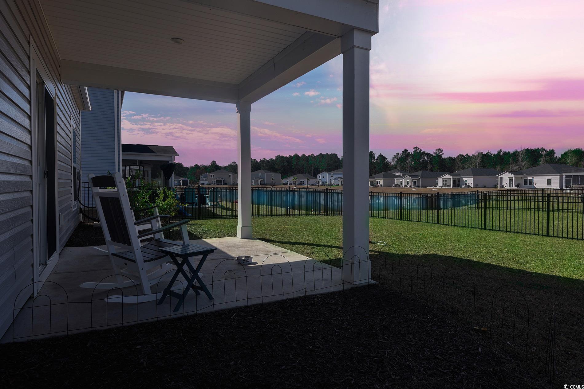 177 Fox Rae Drive Conway, SC 29526 - Photo 26 of 39 Yard at dusk with a patio area, a water view, a fenced backyard, and a residential view