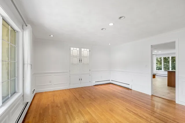 wooden floor in an empty room with a window