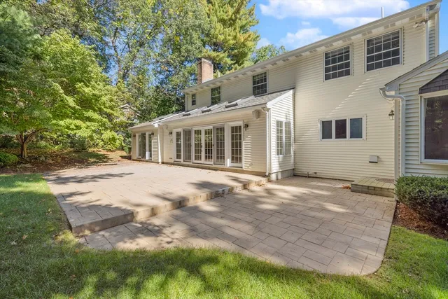 a view of a house with backyard and sitting area