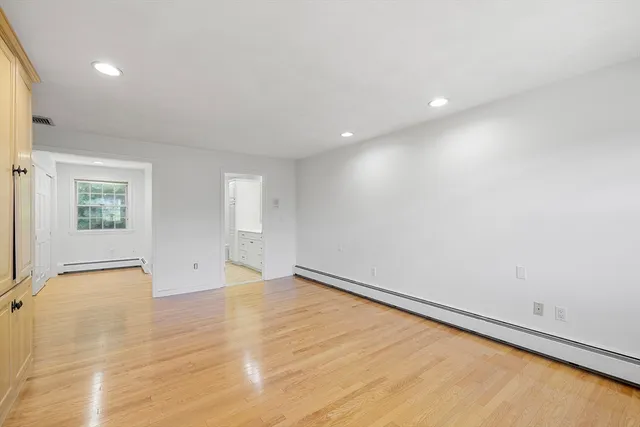 a bathroom with a double vanity sink toilet mirror and shower