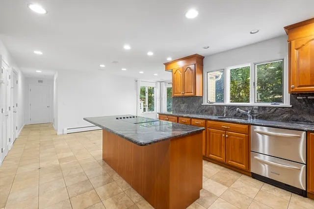 a kitchen with stainless steel appliances granite countertop a sink and a stove